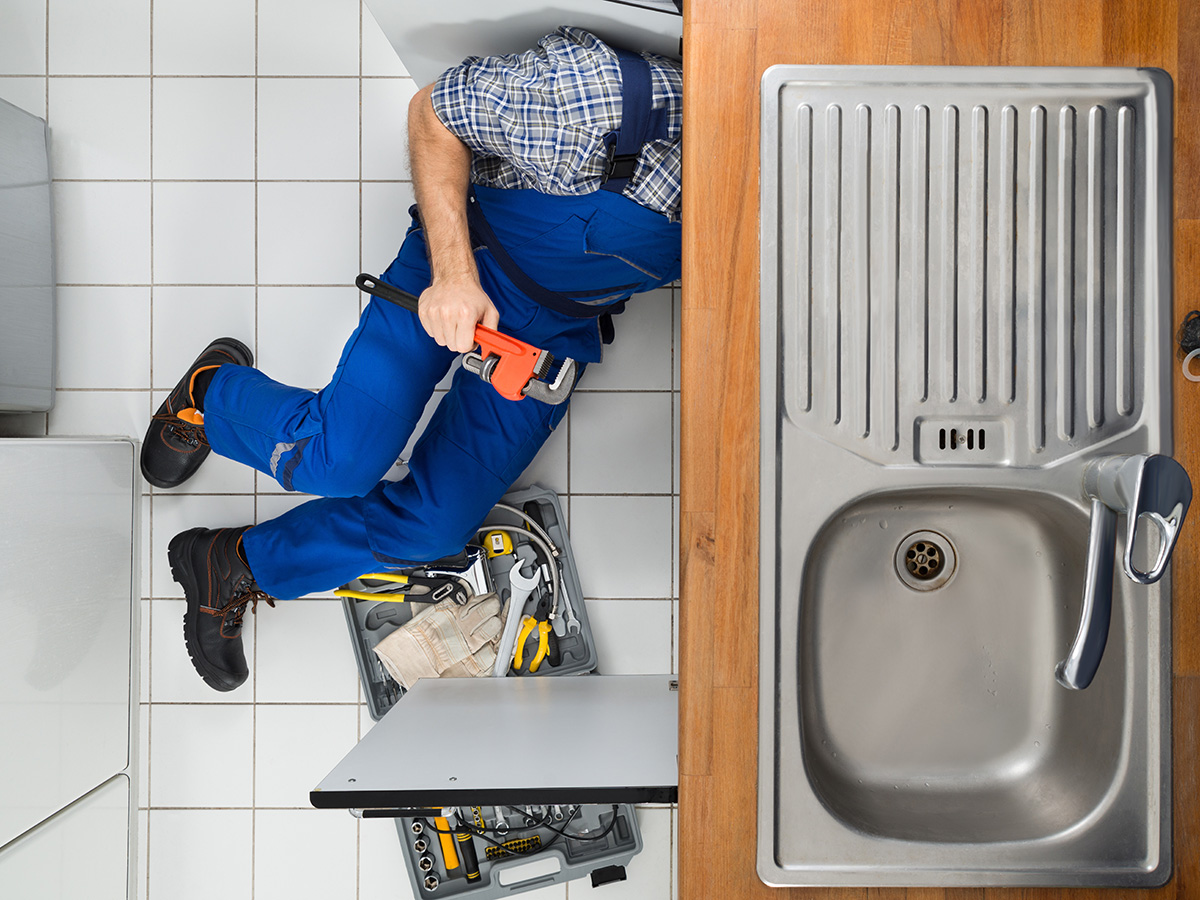 Klempner bei der Abflussreinigung in der Küche – Sanitär Express